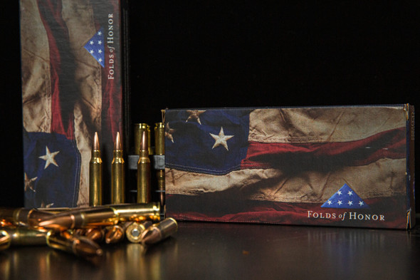 Sierra MatchKing Competition Ammunition, .300 BLACKOUT, 220 grain, Folds of Honor edition. The box features an American flag design with stars, emphasizing the partnership with Folds of Honor. Displayed are several bullets with copper jackets, showcasing the high-quality and purpose-driven design of this precision ammunition for competitive shooting.