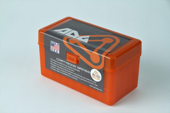 ADG Brass orange ammunition box for 338 Lapua Magnum cartridges, displaying a bold logo and American flag on the label along with detailed product specifications. This sturdy plastic box is designed for secure cartridge storage and transportation, holding up to 50 pieces. Perfect for retailers and ammunition collectors.