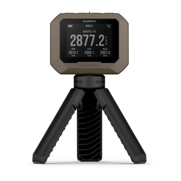 The image displays the Garmin Xero C1 Pro Chronograph mounted on a tripod. This device is showing a bullet's velocity reading in feet per second (fps), which is essential information for precision shooting and ballistics analysis. Chronographs like the Garmin Xero C1 Pro are valuable tools for shooters and reloaders to accurately measure the speed of their bullets, which is a key factor in calculating bullet trajectory and energy. The portability and ease of setup, as illustrated by the tripod in the image, make such devices very convenient for use at shooting ranges or in field conditions.