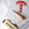 Red toadstool lino print on Artway Indigo Seed Paper with an Artway lino cutting tool