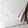 Artway Indigo Seed Paper — fanned sheets showing the speckled, rustic cotton surface