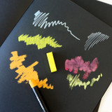 Artway A4 Black Paper Sketchbook — A4 softback shown at an angle with different media applications