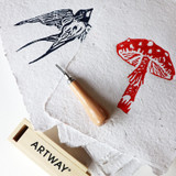 Navy swallow and red toadstool lino prints on Artway Indigo Seed Paper
