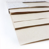 Corner of a stack of Artway Tree Free Hemp Paper A4 sheets in a natural cream colour
