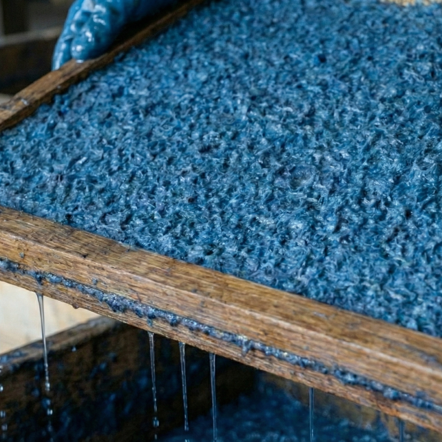 Textile fibres beaten and pulped into paper