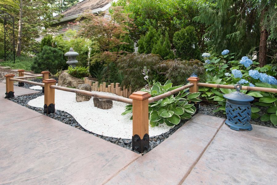 4x4 Original Miterless wood post caps on posts around a garden walkway