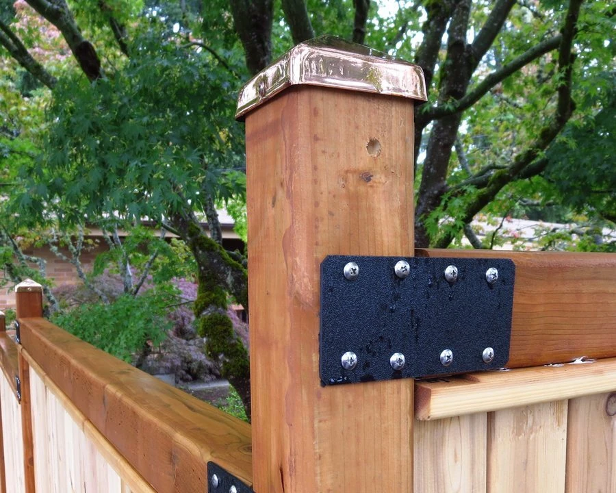 Copper pyramid post cap installed on a 6x6 cedar fence post