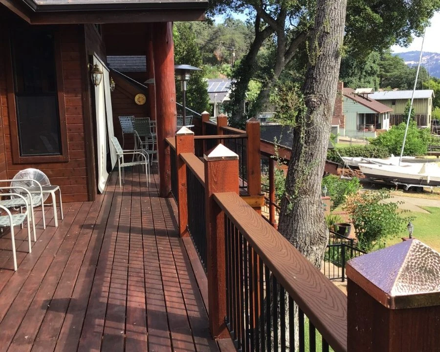 Hammered copper post caps installed along a deck railing
