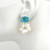 Medium Oval Blue Topaz and Carved Mother of Pearl Flower Drop Earrings