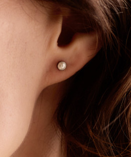 Silver titanium bezel pearl earrings on model 