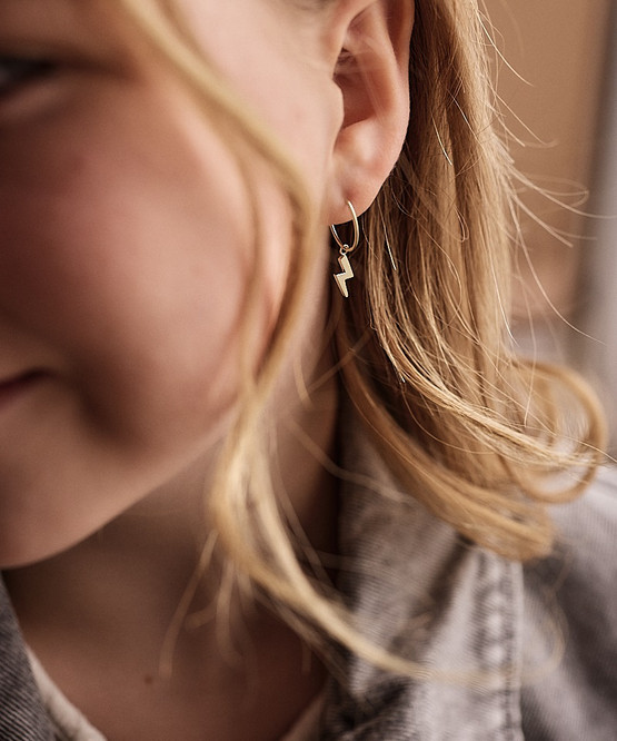 Model Wearing Hypoallergic Golden Titanium 11mm Pendant Flash Ear Ring