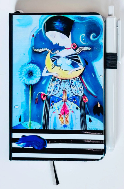 Blue girl holding the moon pocket journal