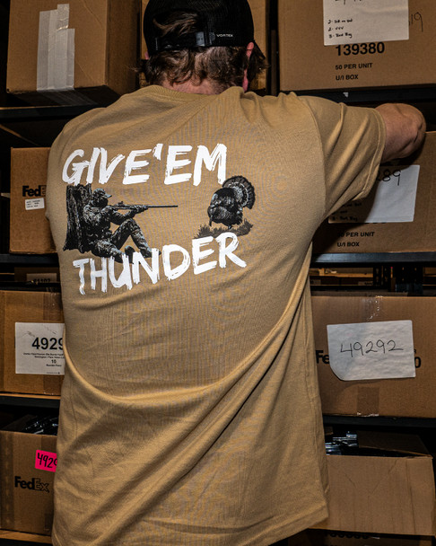 Rear view of a person wearing the EGW Give'Em Thunder Turkey T-shirt in the field, showing the back graphic during outdoor use.