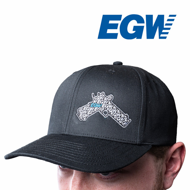 EGW Zeroed Hat worn on a person from front 3/4 angle. Features a bold competition-inspired graphic of a 1911/2011 pistol equipped with a red dot sight. Structured fit with pre-curved bill, perfect for range days and everyday wear.