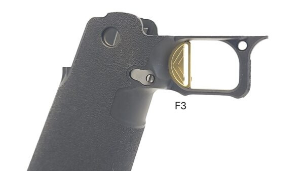 Right side view of the Red Dirt ST F3 Stepped Face gold Trigger installed in a Springfield Prodigy grip module, showing the fit and appearance of the trigger in the frame.