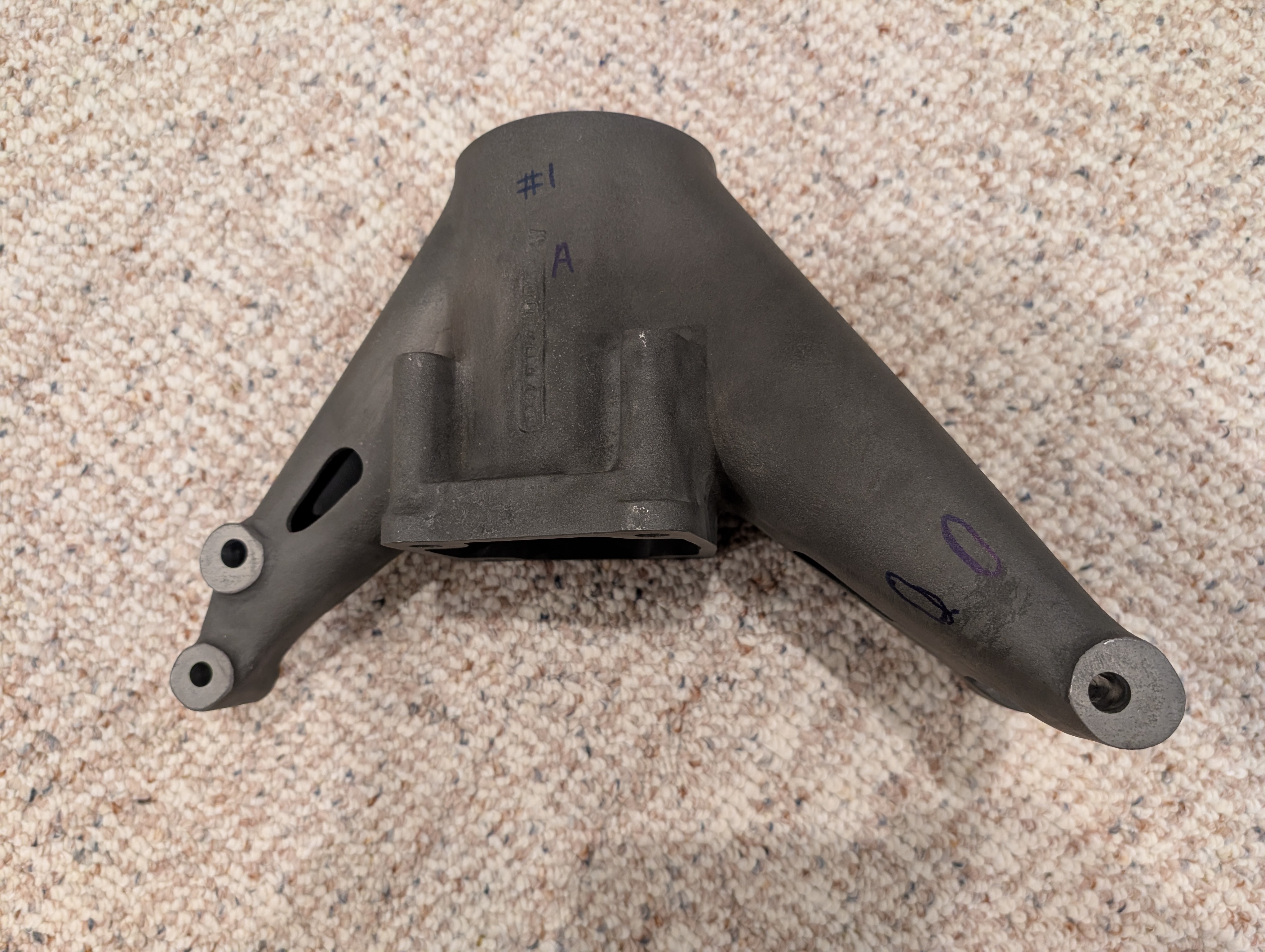 Worn cast suspension upright removed from a historic race car.