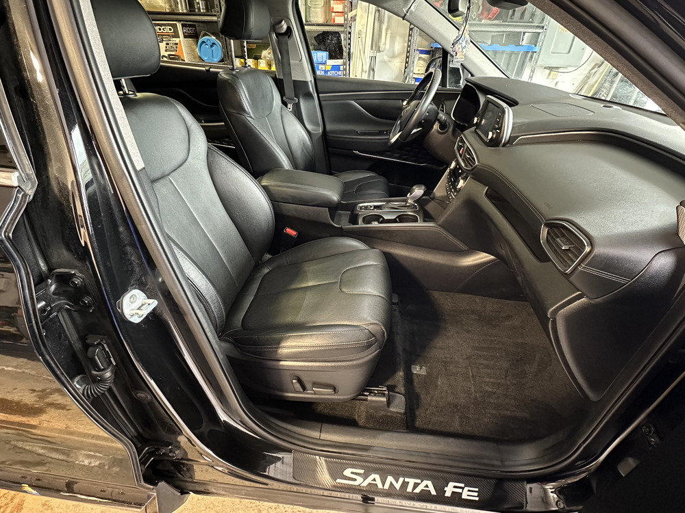 Interior of a black Hyundai Santa Fe showing the seat that will be reupholstered