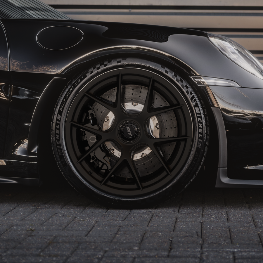 Close up of the Oblivion break system installed on a black Porsche