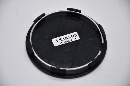 Back of the KMC 1538S03 snap-in center cap showing its mounting features for comparison with an existing KMC wheel cap.