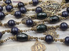 Here's a concise and descriptive image alt text line that incorporates relevant keywords for better Google SEO:

Vintage bronze rosary with 12mm blue sandstone beads, featuring Joan of Arc, St Michael, and St Raphael medallions, perfect for Catholic prayer and devotion.