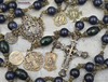 Here's a concise and descriptive image alt text line that incorporates relevant keywords for better Google SEO:

Vintage bronze rosary with 12mm blue sandstone beads, featuring Joan of Arc, St Michael, and St Raphael medallions, perfect for Catholic prayer and devotion.