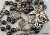 Vintage bronze chaplet with black onyx beads, featuring devotional Archangel Michael and St Benedict medallions, a treasured heirloom for Catholic prayer.