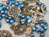 Unique antique-style heirloom rosary with blue mystic agate and peridot beads, featuring solid bronze medals of Our Lady of Guadalupe, Sacred Heart of Jesus, Our Lady of the Rosary, and sun and moon symbols for Catholic devotion.