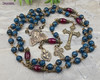 Vintage bronze rosary with blue jade and red agate prayer beads, featuring a Jesus Sacred Heart medallion, perfect for Catholic devotion and meditation.