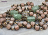 Unique antique-style heirloom rosary featuring solid bronze medals of a radiant Fatima center, sun medal associated with miracles, and a symbolic Miraculous Mary with a snake under her feet, crafted with peach moonstone and green strawberry quartz beads for Catholic devotion and prayer.