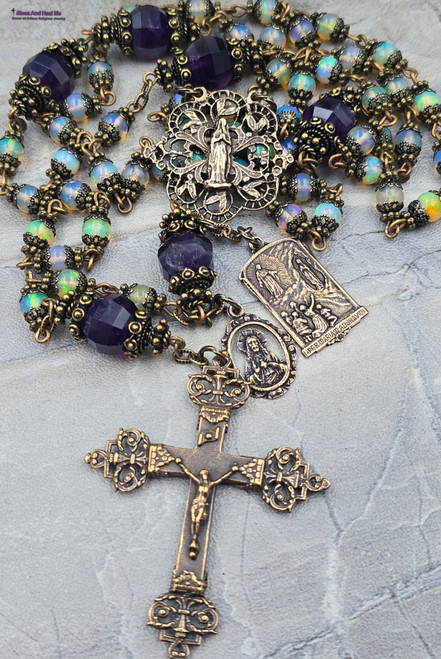 Unique ornate antique-style heirloom rosary featuring solid bronze medals of Blessed Virgin Mary, Our Lady of Lourdes, Glory of Jesus, Immaculate Conception, and Sacred Heart of Jesus, crafted with colorful genuine fire opal and amethyst beads for Catholic prayer and devotion.