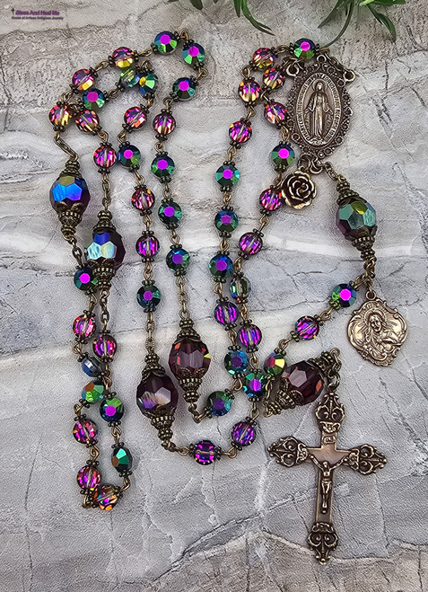 Unique antique-style heirloom rosary featuring solid bronze medals of Miraculous Mary, Sacred Heart of Jesus, and St. Therese, crafted with genuine Austrian Swarovski crystal vitrail and amethyst Aurora Borealis beads for Catholic devotion and prayer.