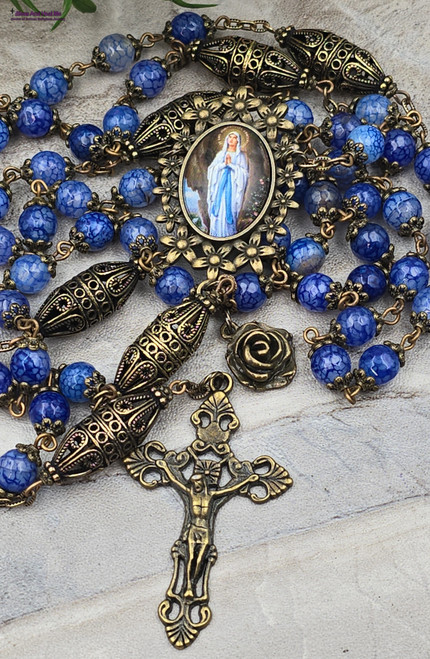Handcrafted ornate bronze-tone rosary featuring Our Lady of Lourdes centerpiece and blue agate beads for healing, vitality, love, happiness, and protection
