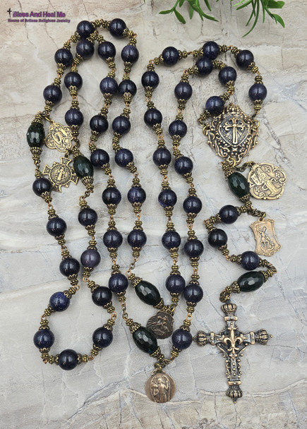 Here's a concise and descriptive image alt text line that incorporates relevant keywords for better Google SEO:

Vintage bronze rosary with 12mm blue sandstone beads, featuring Joan of Arc, St Michael, and St Raphael medallions, perfect for Catholic prayer and devotion.