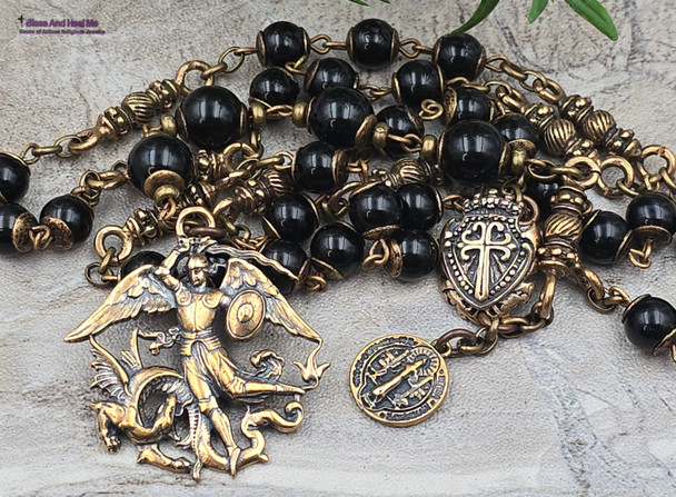 Vintage bronze chaplet with black onyx beads, featuring devotional Archangel Michael and St Benedict medallions, a treasured heirloom for Catholic prayer.