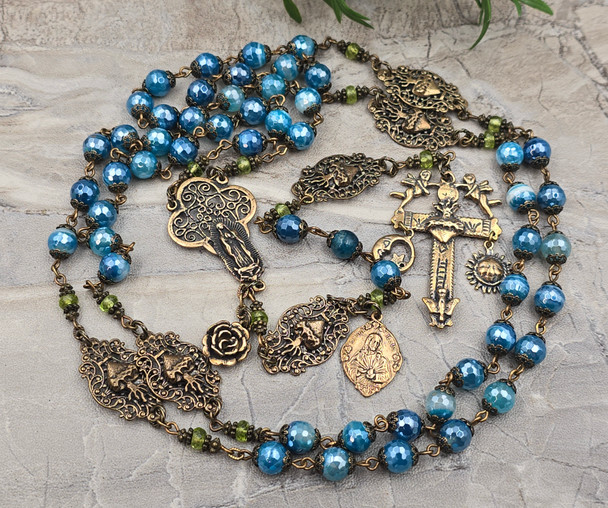 Unique antique-style heirloom rosary with blue mystic agate and peridot beads, featuring solid bronze medals of Our Lady of Guadalupe, Sacred Heart of Jesus, Our Lady of the Rosary, and sun and moon symbols for Catholic devotion.