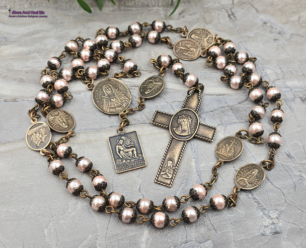 Devotional chaplet with peach pearl shell beads and solid bronze medals featuring the Seven Sorrows, Seven Dolores, Pieta, Lord of Good Hope, Crown of Thorns, Holy Sacraments, and Sacred Heart of Jesus for Catholic prayer and meditation.