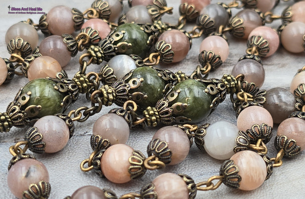 Antique-style heirloom rosary with peach moonstone and green jade beads, featuring solid bronze medals of Jesus, Blessed Virgin Mary, Sacred Heart of Jesus, and Immaculate Heart of Mary for Catholic devotion and prayer.