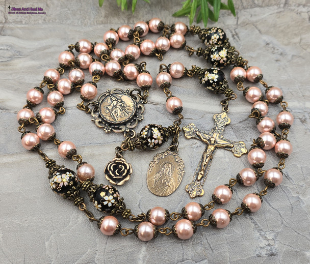 Antique-style heirloom rosary featuring solid bronze medals of Our Lady of Carmel and the Sacred Heart of Jesus, crafted with peach pearl shell and floral Tensha beads for Catholic devotion and prayer.