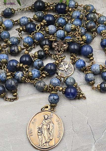 Deepen your devotion to St. Joseph with this exquisite heirloom-quality bronze chaplet featuring St. Joseph with Guardian Angel, Holy Spirit medals, and sodalite and lapis lazuli beads.