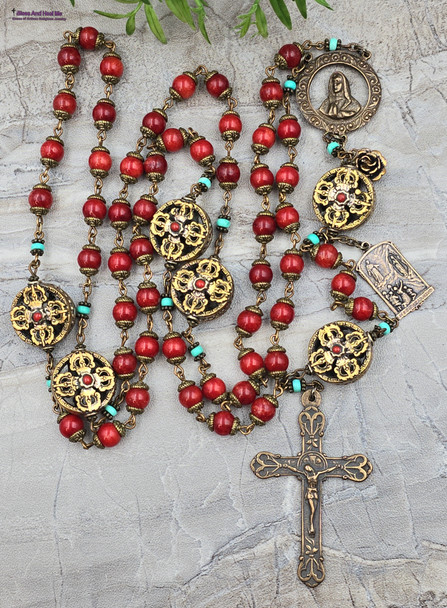 One-of-a-kind ornate antique-style heirloom rosary with solid bronze medals of Blessed Virgin Mary, Jesus, and Our Lady of Lourdes, crafted with coral red jade and turquoise beads.