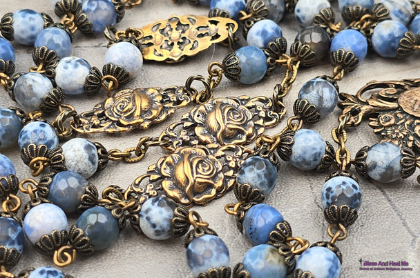 Ornate antique-style heirloom rosary with bronze medals of Our Lady of Lourdes, Miraculous Mary, Archangel Raphael, Guardian Angel, and St. Jude, crafted with blue agate beads.