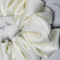 Tuhil Threads Large Cream Royal Micro Satin Scrunchie. Luxurious large satin hair tie for a gentle, stylish hold. Shop Tuhil Threads hair accessories.