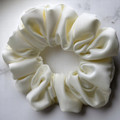 Tuhil Threads Medium Cream Royal Micro Satin Scrunchie. Luxurious medium satin hair tie for a gentle, stylish hold. Shop Tuhil Threads hair accessories.
