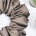 Tuhil Threads Medium Taupe Royal Micro Satin Scrunchie. Luxurious medium satin hair tie for a gentle, stylish hold. Shop Tuhil Threads hair accessories.