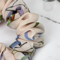 Tuhil Threads Medium Floral Print Scrunchie. Charming medium hair tie with a beautiful multi-colour floral design, offering a stylish and gentle hold. Shop Tuhil Threads hair accessories.