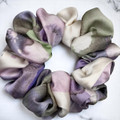 Tuhil Threads Medium Cool Tone Abstract Silky Satin Scrunchie. Smooth and lustrous medium silky satin hair tie featuring a beautiful abstract design in cool purple and green hues for a sophisticated, gentle hold. Shop Tuhil Threads hair accessories.