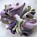 Tuhil Threads Medium Cool Tone Abstract Silky Satin Scrunchie. Smooth and lustrous medium silky satin hair tie featuring a beautiful abstract design in cool purple and green hues for a sophisticated, gentle hold. Shop Tuhil Threads hair accessories.