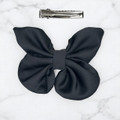 Tuhil Threads small black Royal Micro Satin butterfly bow  showcasing its classic colour and elegant shape. Shop Tuhil Threads hair accessories.