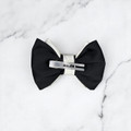 Tuhil Threads Small Royal Micro Satin Classic Bow in a two-tone design with a bold black bottom layer and a cream top layer, neatly tied. Shop Tuhil Threads hair accessories.