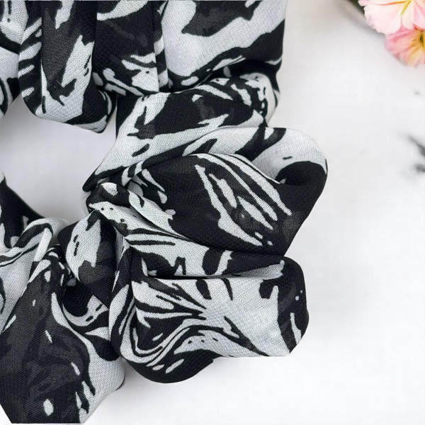 Tuhil Threads Large Black and White Abstract Print Chiffon Scrunchie. Lightweight large chiffon hair tie with a bold monochrome design for a stylish, gentle hold. Shop Tuhil Threads hair accessories